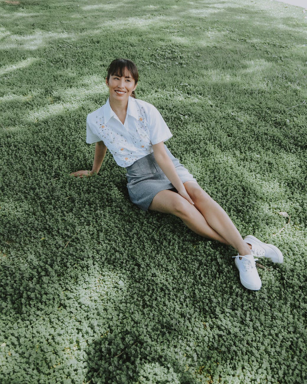 high angle photo of woman sitting on grass