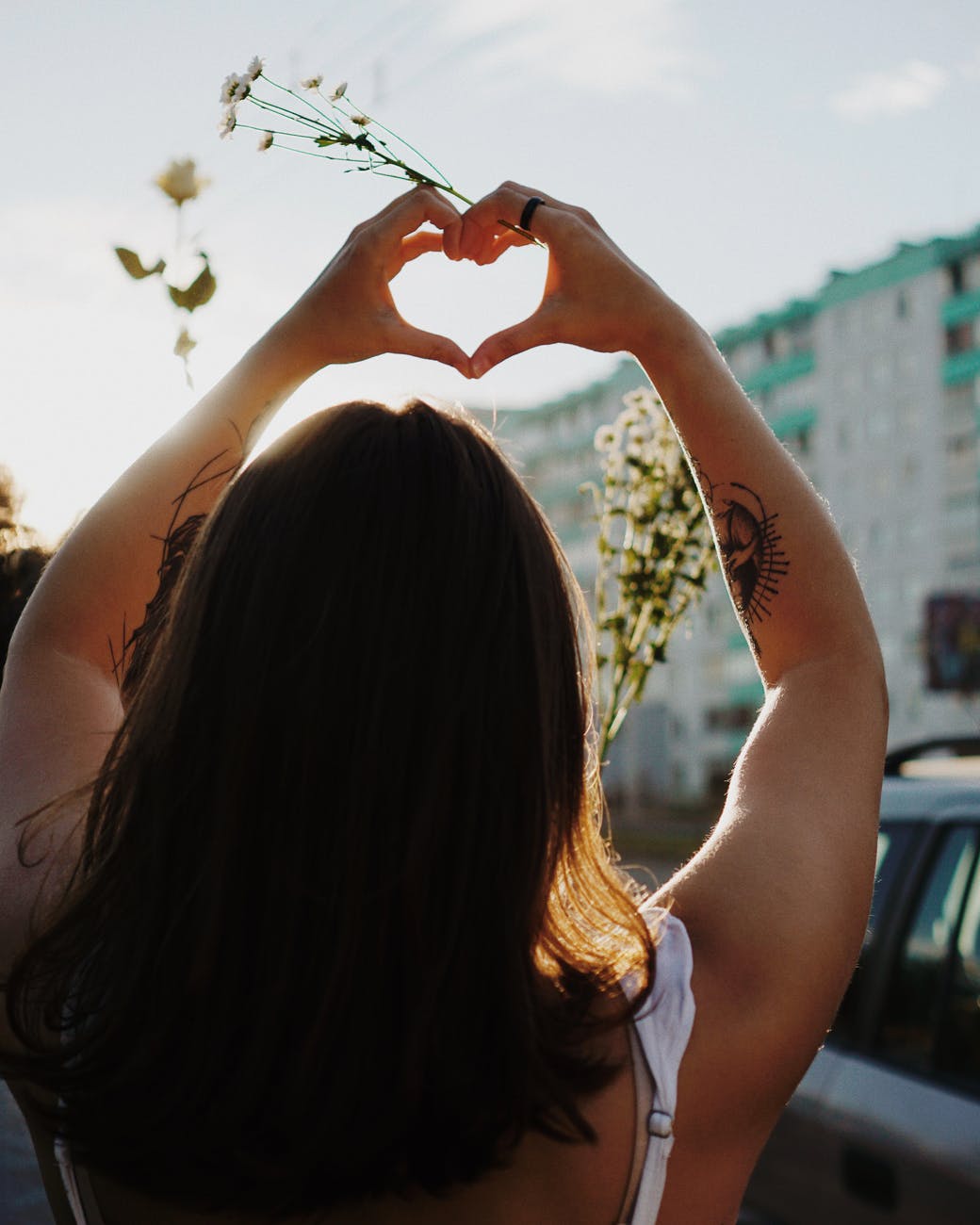 woman shaping heart with hands