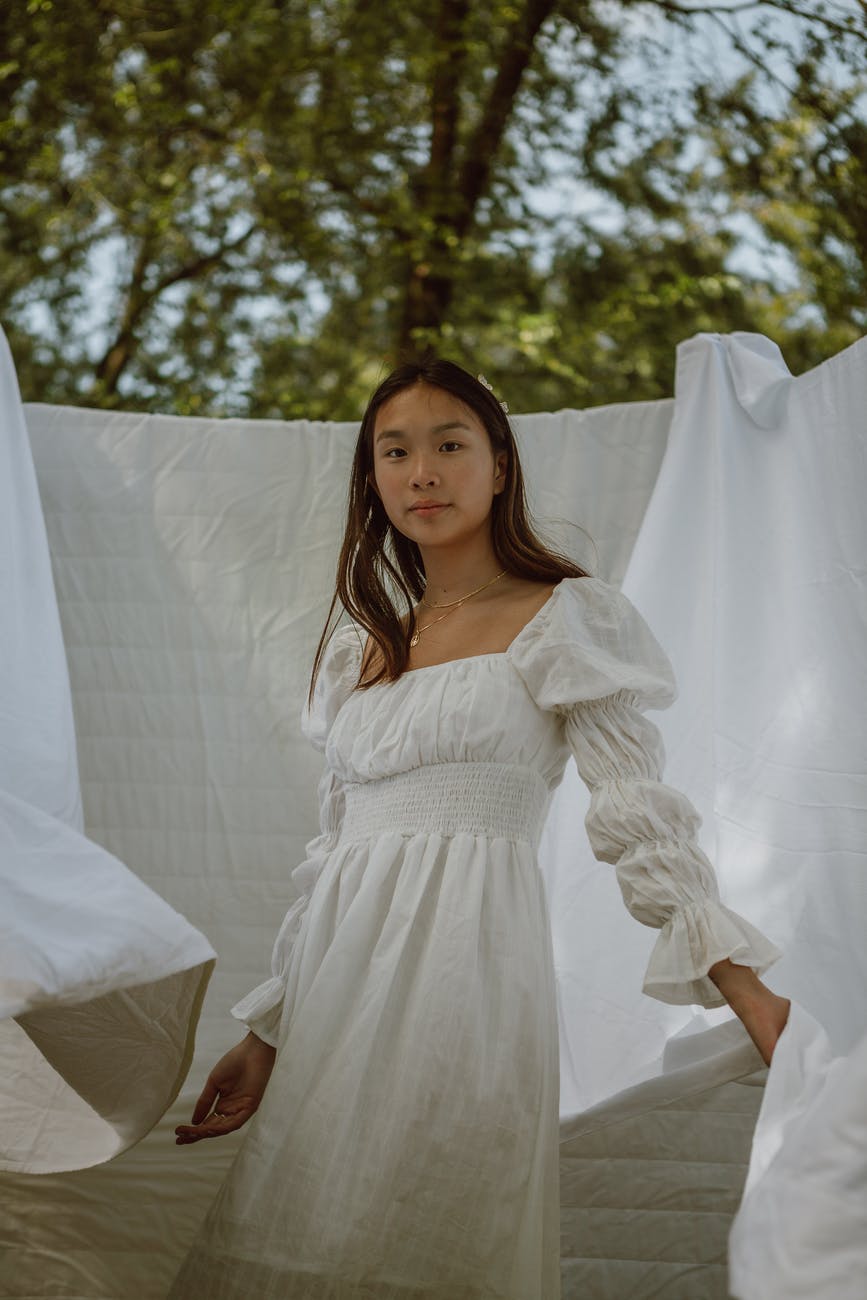 elegant young asian bride relaxing in green park